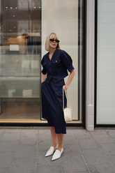 a lady wears a denim midi skirt with matching denim shirt